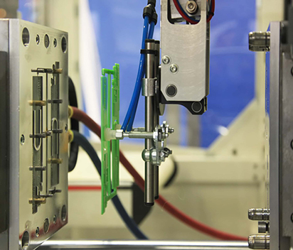 Injection molding machine construction with precision ground chrome plated stanchion rods